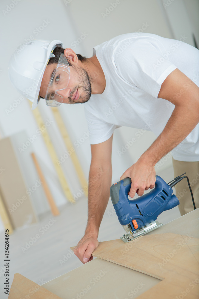 worker cutting a plywood worker cutting a plywood