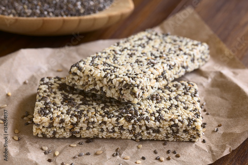 Chia sesame honey granola bars, photographed with natural light (Selective Focus, Focus on the front edge of the granola bars)