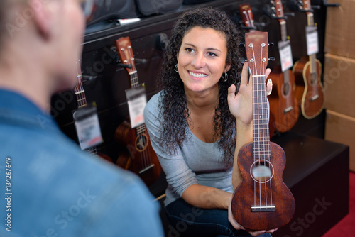 Woman showing miniature guitar