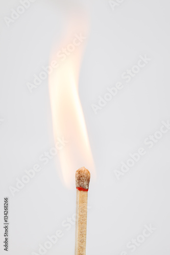 Strong burning match on light background