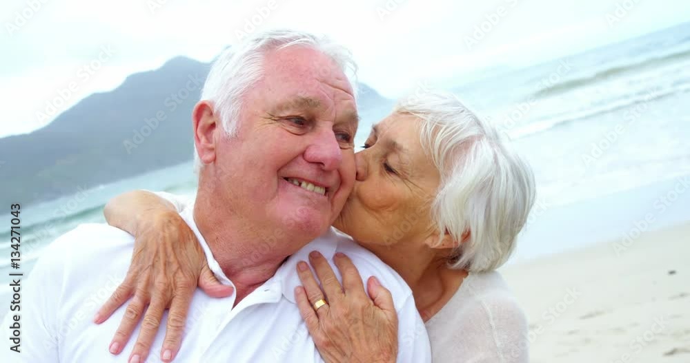 Senior couple embracing each other on the beach Senior couple embracing each other on the beach
