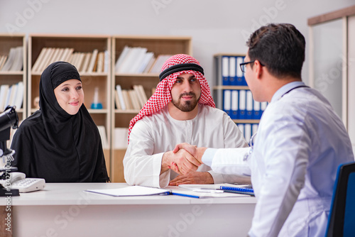 Doctor consulting arab family at hospital