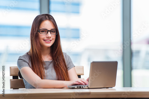 Free Download Young businesswoman working on laptop - GFXLoad