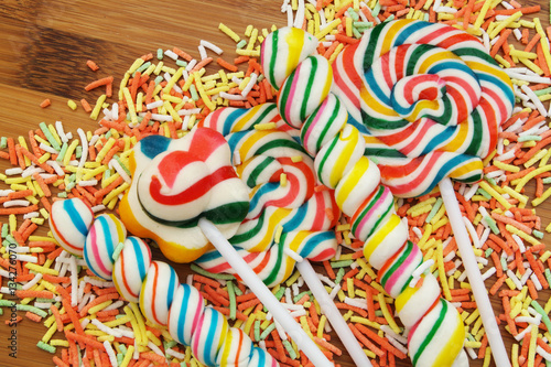 Colorful fruit lollipop candies mixed together close up.