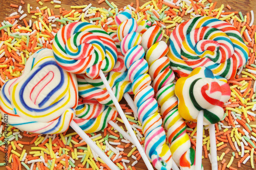 Colorful fruit lollipop candies mixed together close up.