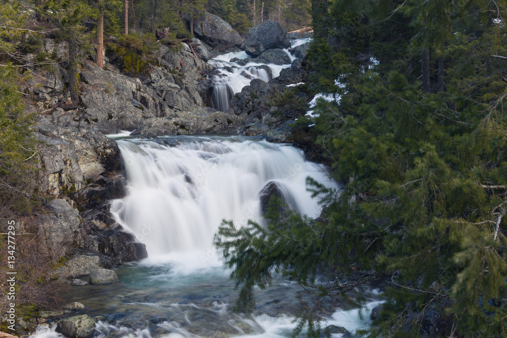 Long exposure of a small waterfall full of spring snowmelt in a granite canyon in the Trinity Alps Long exposure of a small waterfall full of spring snowmelt in a granite canyon in the Trinity Alps