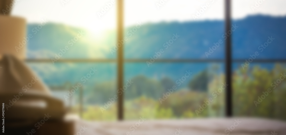 blurred  Image looking through big window at beautiful foggy hills with colorful sunset.