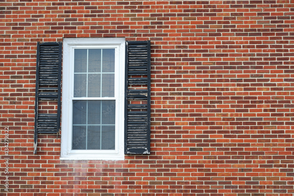 close up on damaged window shutter on brick wall close up on damaged window shutter on brick wall