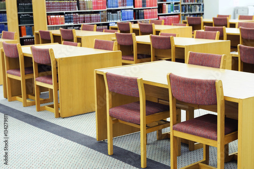 interior view of library with tables and chairs in university