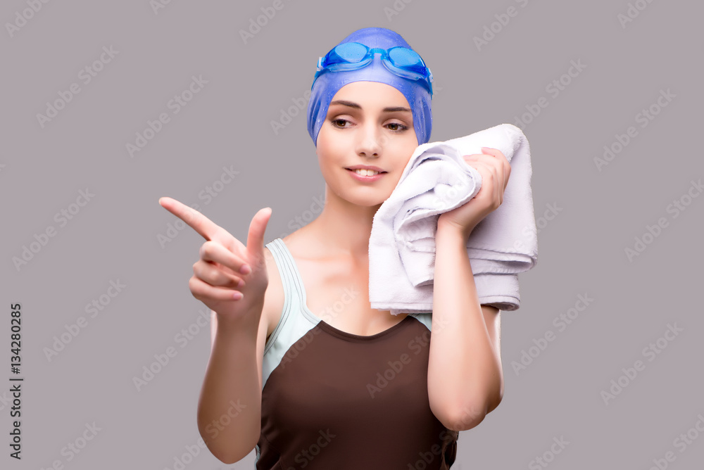 Woman swimmer against grey background Woman swimmer against grey background