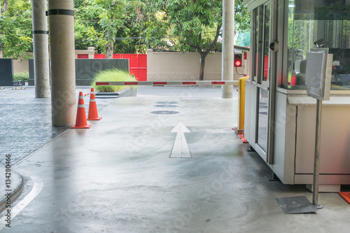 Security system for building access - barrier gate stop with toll booth, traffic cones and cctv