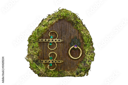 Fairy door with moss on isolated background/Fairy door with moss, wood, brass ornaments and jewels