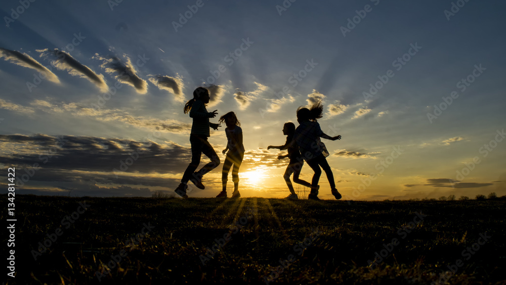 Children playing in the setting sun