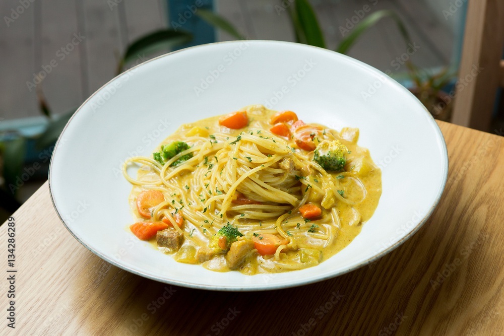 curry pasta on wooden table