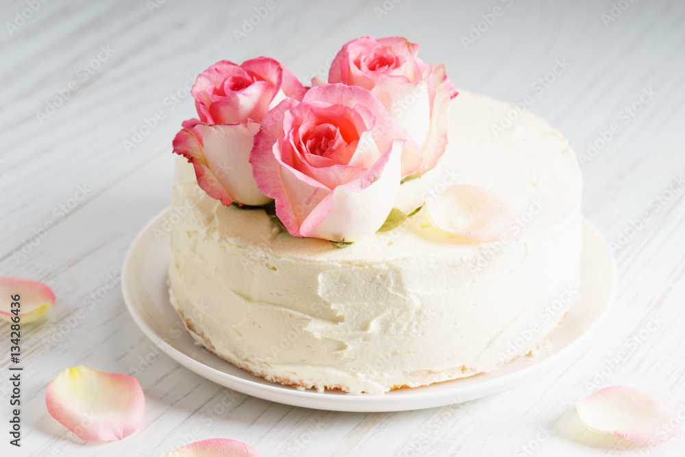 sweet white buttercream cake with pink rose flowers on top sweet white buttercream cake with pink rose flowers on top