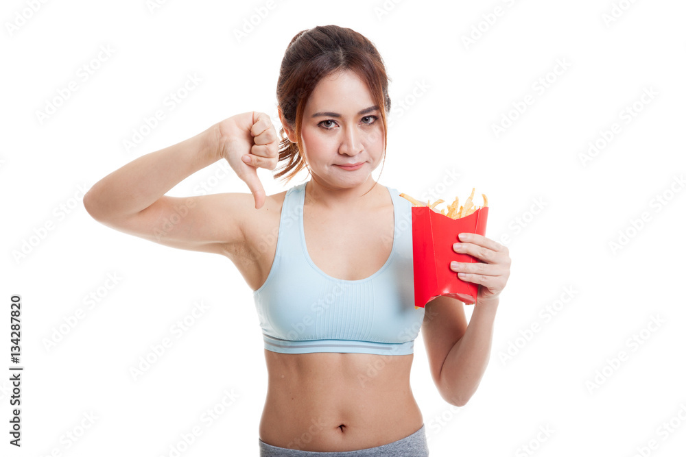 Asian healthy girl thumbs down with french fries. Asian healthy girl thumbs down with french fries.