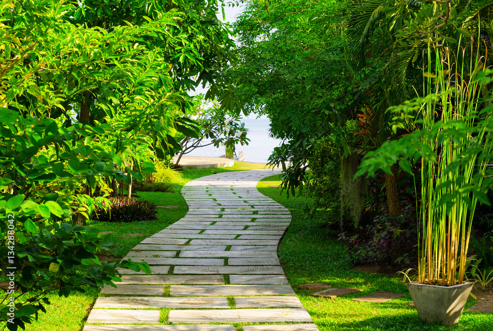 Stone path among green trees Stone path among green trees