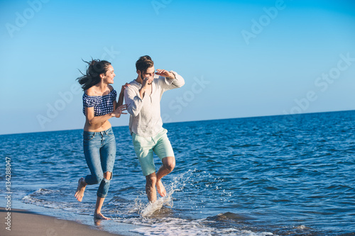 happy couple running on the beach