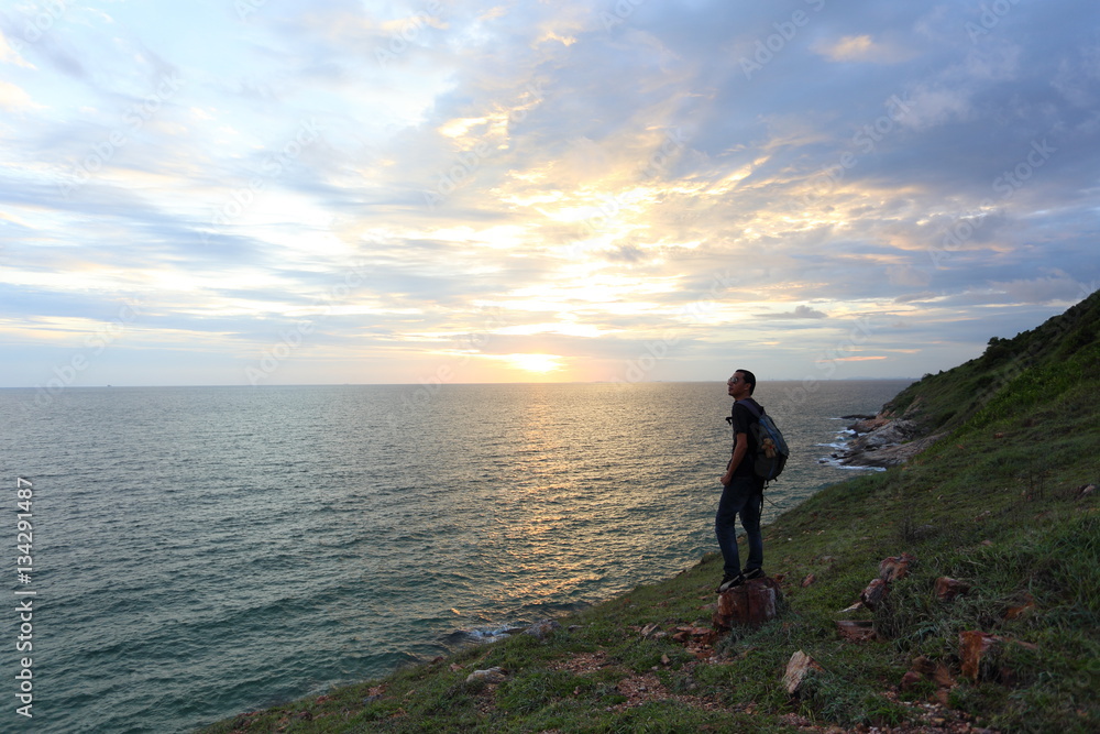 Man standing at Khao Laem Ya national park and sunset in Rayong ,Thailand