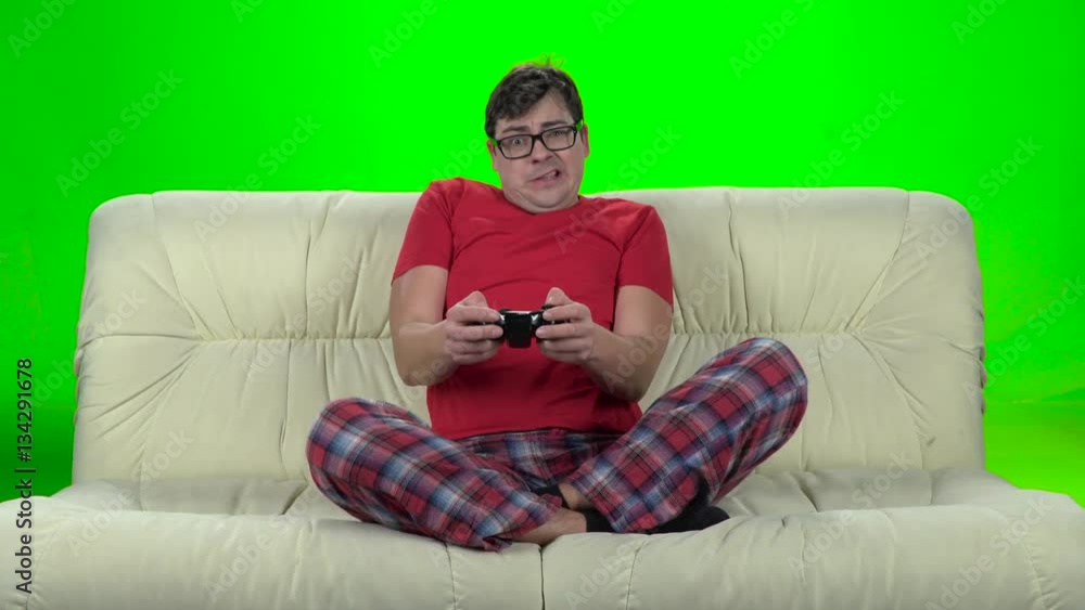 Funny man in glasses plays on a gamepad video game Funny man in glasses plays on a gamepad video game