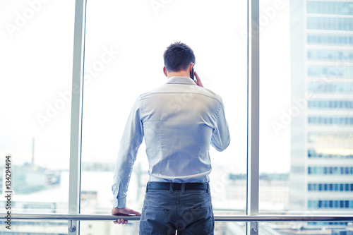 businessman calling on smartphone in office