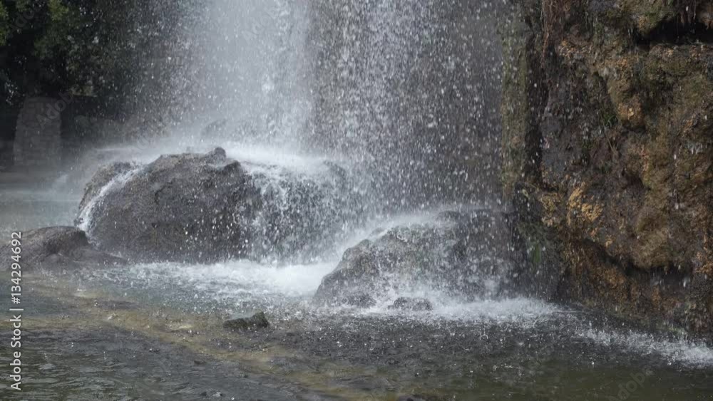 Water splashes falling in nature pool cascade. Close up details stones in river. Water splashes falling in nature pool cascade. Close up details stones in river.