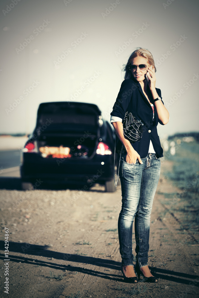 Fashion woman next to broken car calling on cell phone Fashion woman next to broken car calling on cell phone