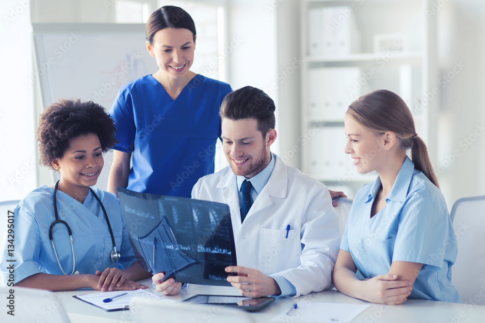 group of happy doctors discussing x-ray image group of happy doctors discussing x-ray image
