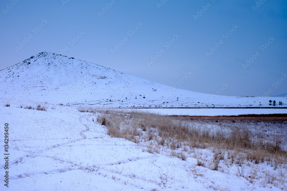View of snow-covered mountains on a cold day View of snow-covered mountains on a cold day