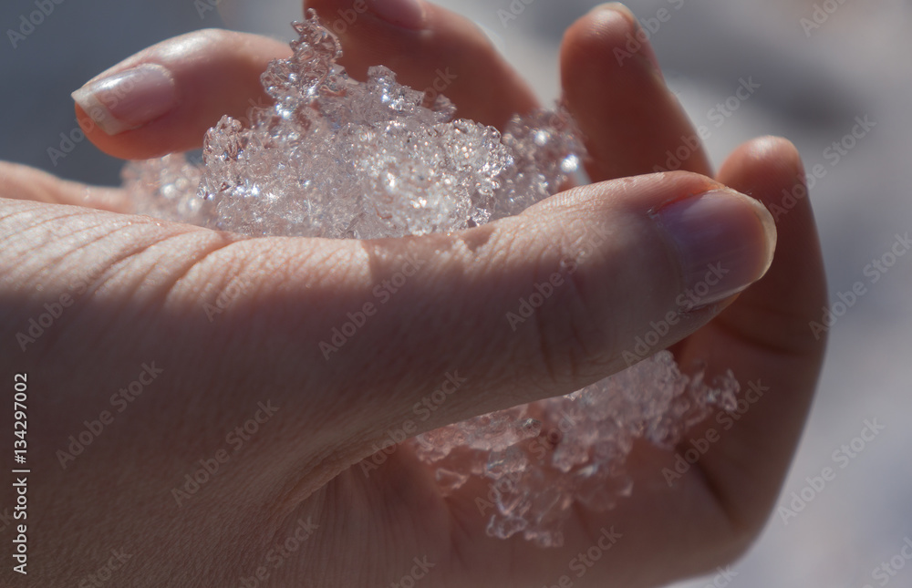 Girl with a frozen hand, shows a beautiful, glowing ice Girl with a frozen hand, shows a beautiful, glowing ice