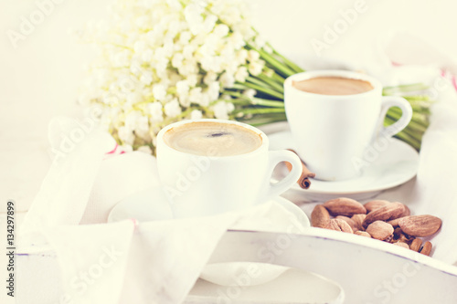 espresso, nuts and bouquet of flowers