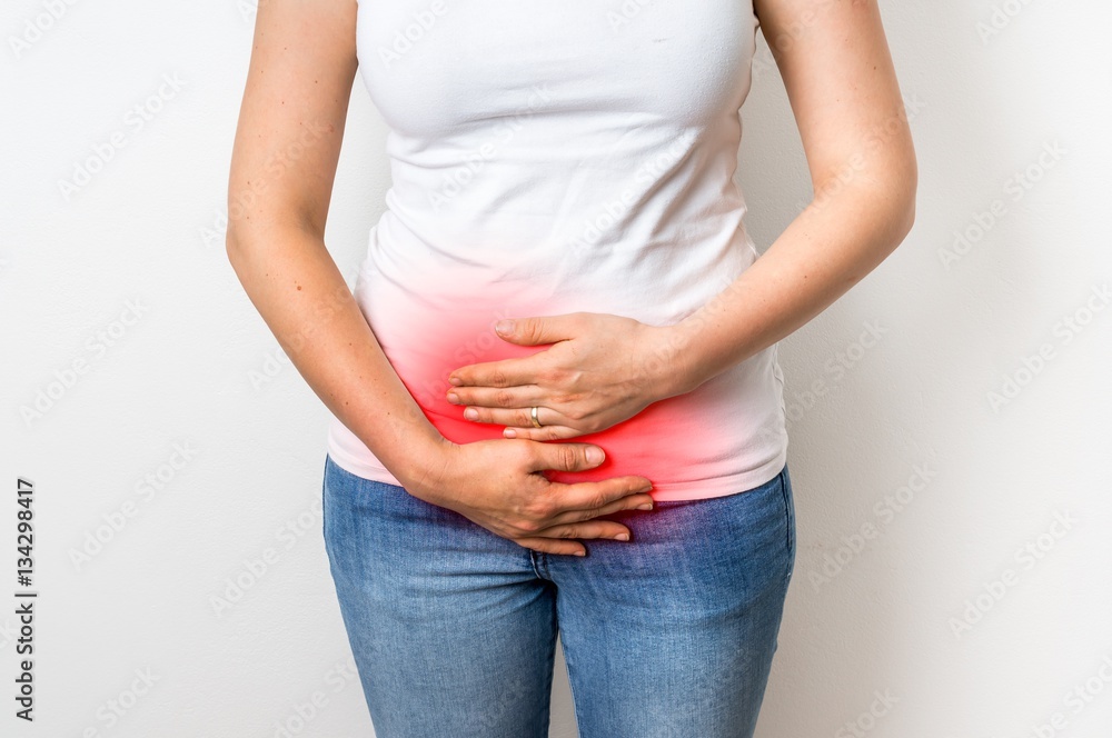 Woman with menstrual pain is holding her aching belly Woman with menstrual pain is holding her aching belly