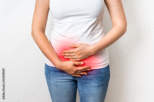 Woman with menstrual pain is holding her aching belly © andriano_cz