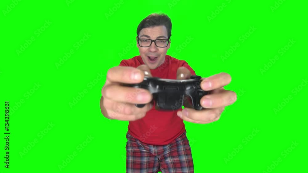 Gamer man makes faces playing on game console. Green screen Gamer man makes faces playing on game console. Green screen