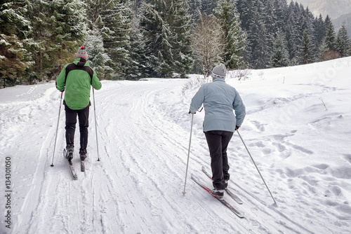 Active seniors. Cross-country skiing photo