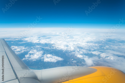 The wing with engine on the background of cloud view