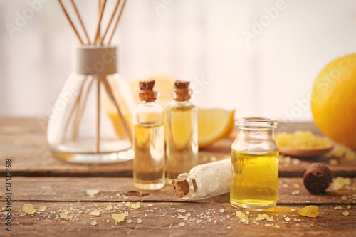 Beautiful spa composition with lemon essential oil on wooden table, closeup