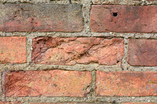 Wall with bricks damaged by the weather