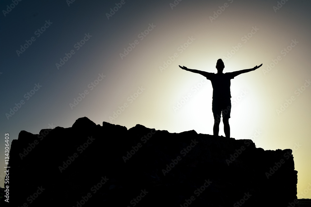silhouette of a man with open arms