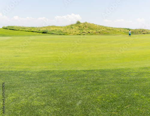 Little kid running on green meadow