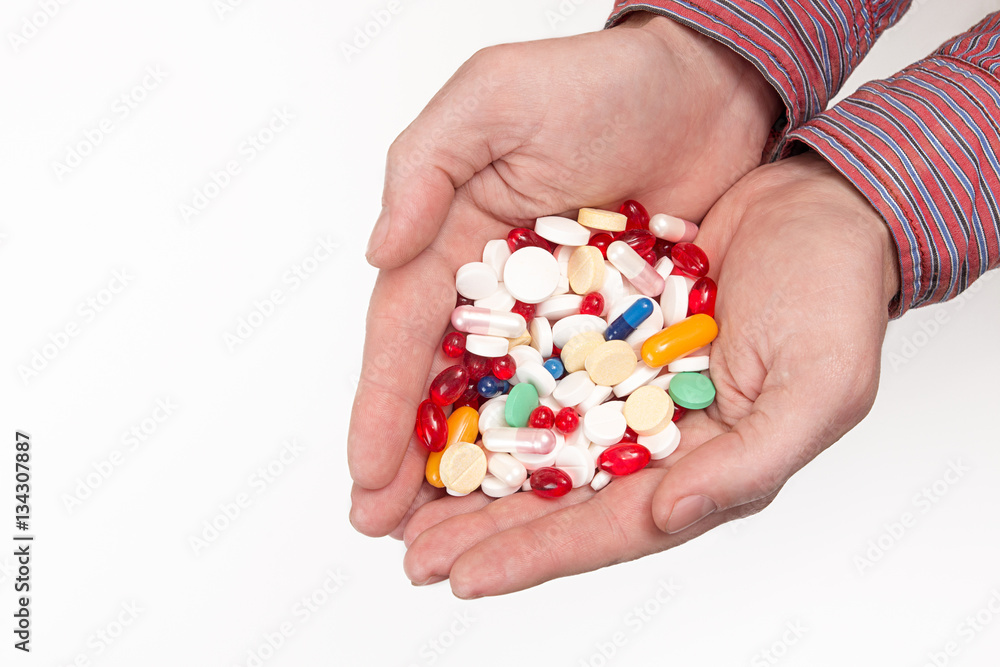 Heap of tablets and pills in man's hands palms Heap of tablets and pills in man's hands palms