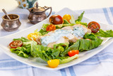 Salad with chicken breast, yogurt dressing and mixed tomatoes.