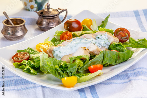 Salad with chicken breast, yogurt dressing and mixed tomatoes.