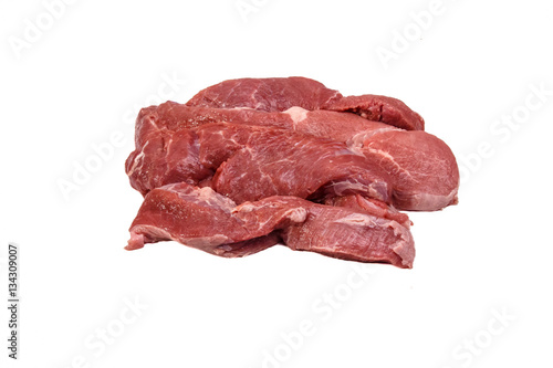 Raw pork meat (hind leg) cut into slices lying on a white backgr