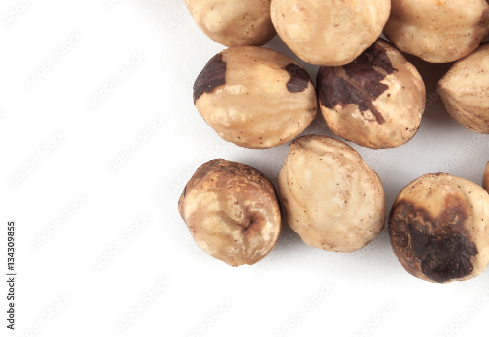 Roasted hazelnuts on white Roasted hazelnuts on white
