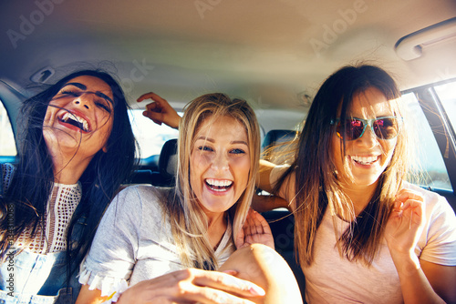Three vivacious girlfriends on a road trip photo