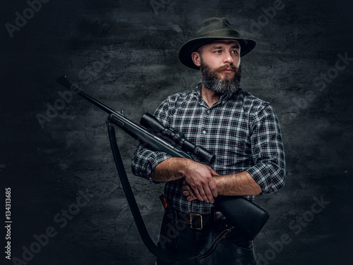 A hunter holds a rifle.