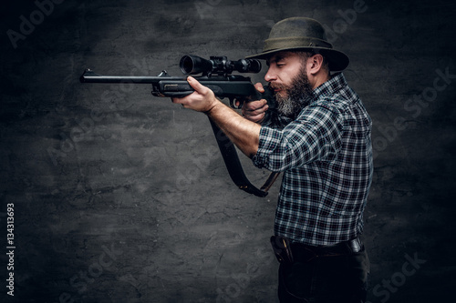 Fotografie, Obraz A hunter holds a rifle.