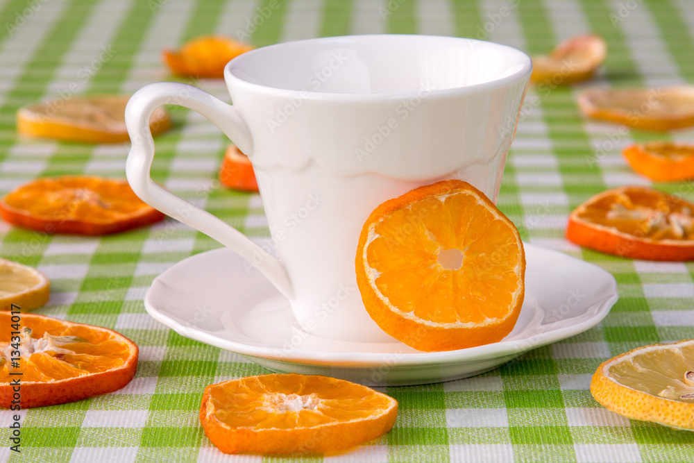 White cup and citrus slices White cup and citrus slices