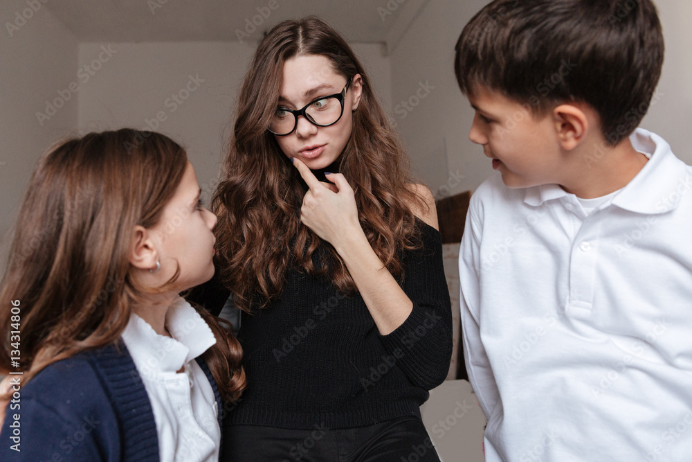 Beautiful young mother talking with her son and daughter Beautiful young mother talking with her son and daughter